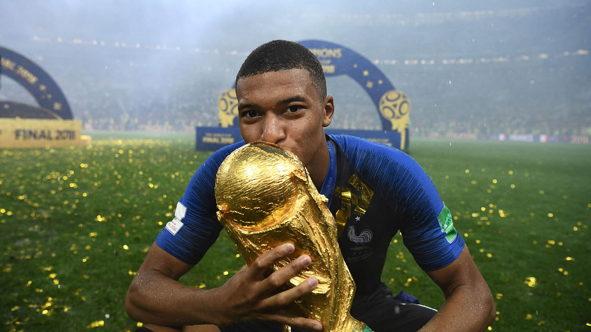 France`s forward Kylian Mbappe kisses the World Cup trophy after the Russia 2018 World Cup final football match between France and Croatia at the Luzhniki Stadium in Moscow on 15 July 2018. Photo: AFP