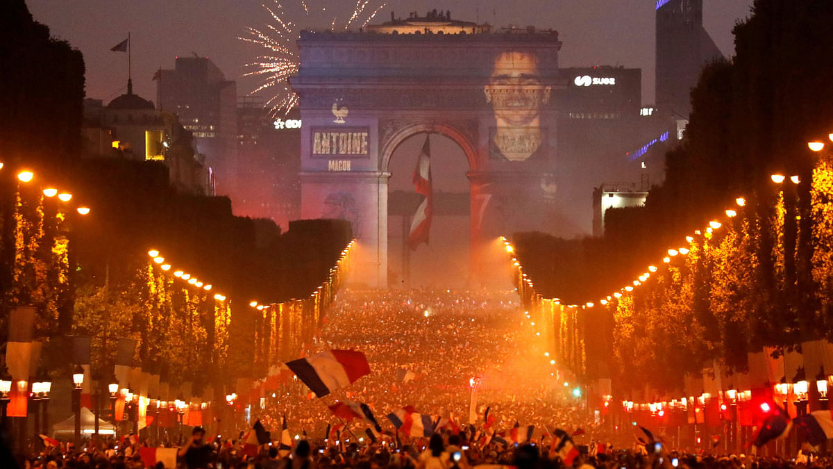 A giant picture of France`s Antoine Griezmann is seen on the Arc de Triomphe as France fans celebrate on the Champs-Elysees Avenue after France won the Soccer World Cup final. Photo: Reuters