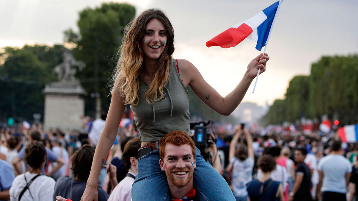 People celebrate France`s victory in the Russia 2018 World Cup final football match between France and Croatia in Paris.  Photo: AFP