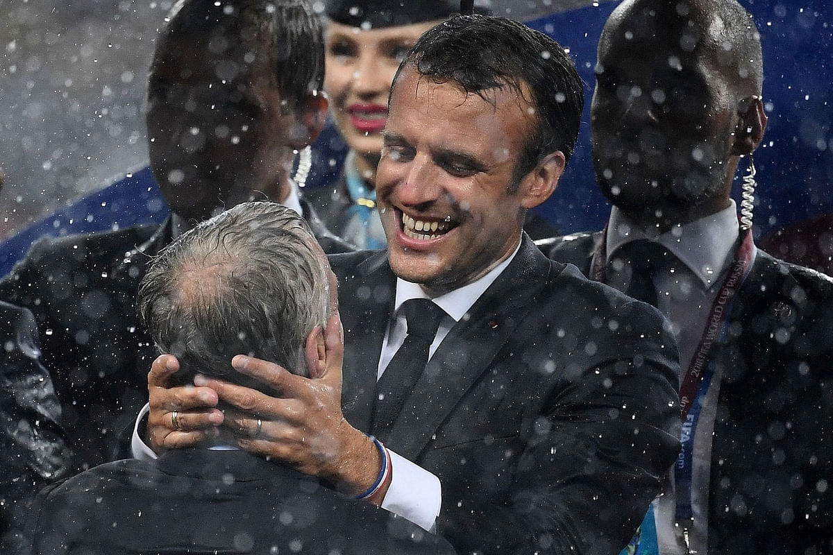 French president Emmanuel Macron (R) congratulates France`s coach Didier Deschamps during the trophy ceremony at the end of the Russia 2018 World Cup final football match between France and Croatia at the Luzhniki Stadium in Moscow on 15 July 2018. -- AFP