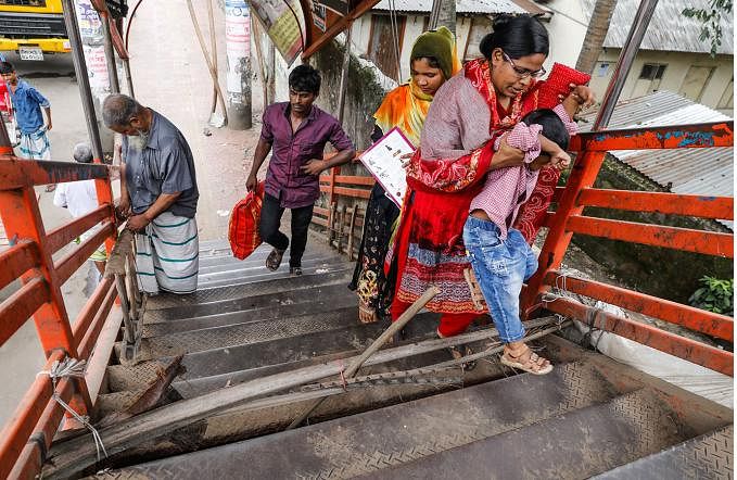 The staircase of the over bridge has broken. The passersby face difficulty while they cross the bridge at Sabujbagh section of Kamalapur over-bridge in Dhaka on 15 July. Photo: Dipu Malakar