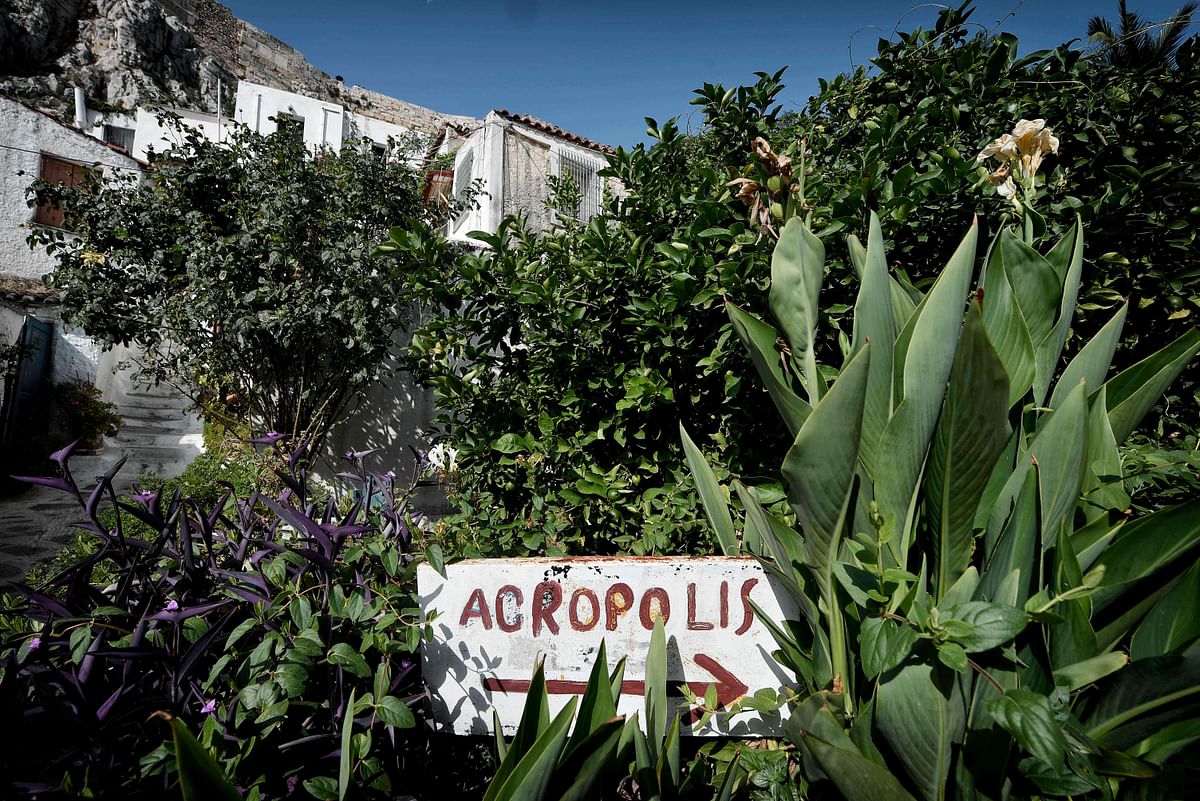 A sign points the way to the Acropolis in the tiny Anafiotika district of Athens, under the Acropolis archaeological site on 6 July, 2018. Photo: AFP