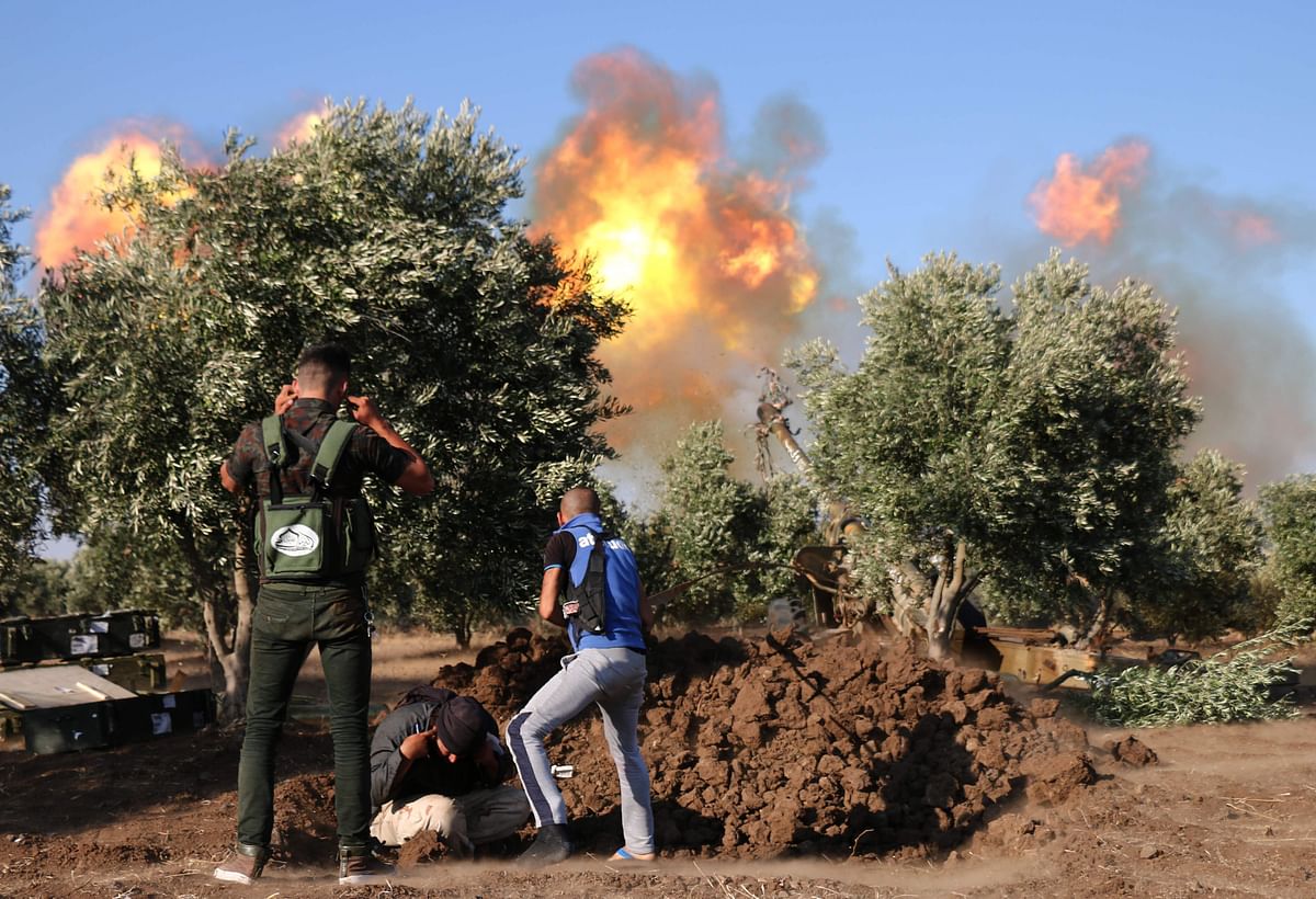 Syrian rebels fire rockets and artillery shells during clashes with regime forces advancing toward the town of al-Hara in the southern Syrian Daraa province on 16 July. Photo: AFP