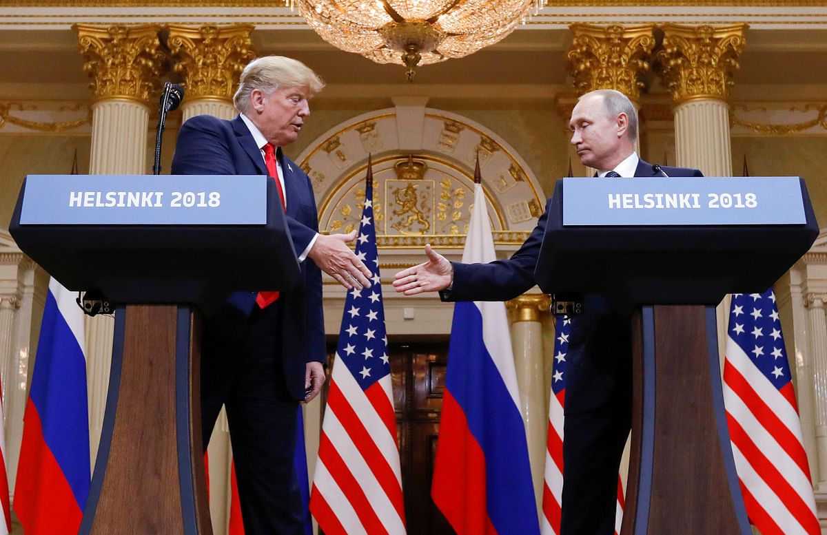 US president Donald Trump and Russia`s president Vladimir Putin shake hands during a joint news conference after their meeting in Helsinki, Finland on 16 July. Photo: Reuters