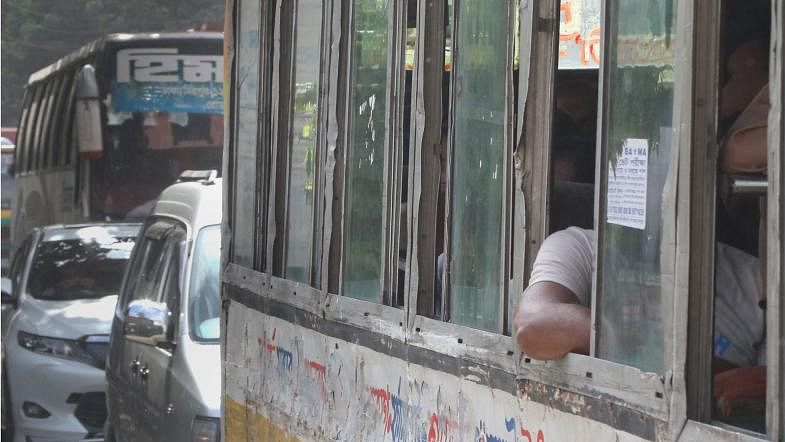 Passengers are occasionally found to stretch out their hands out of the bus window. This may lead to accident. The picture was taken from near the National Press club, Dhaka on 16 July. Photo: Ashraful Alam