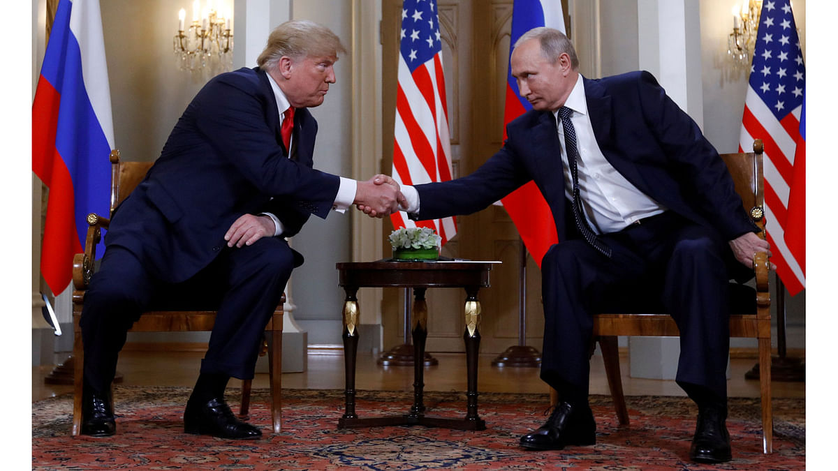US president Donald Trump and Russia`s president Vladimir Putin shake hands as they meet in Helsinki, Finland on 16 July 2018. Photo: Reuters