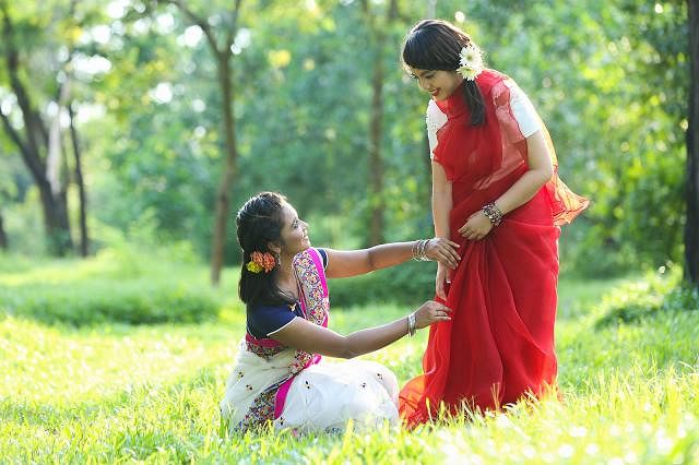 Helping each other wear their saris