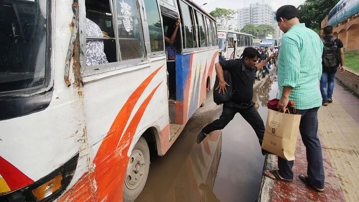 A man jumps over the water to reach the foothpath after the rain. The 17 July photo was taken in Karwan Bazar, Dhaka, by Abdus Salam