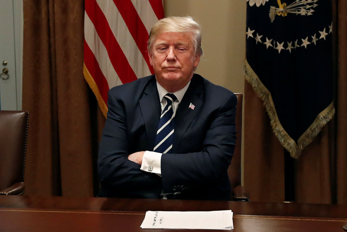 US president Donald Trump waits for reporters to leave the room after speaking about his summit with Russia’s president Putin during a meeting with members of the US Congress at the White House in Washington on 17 July. Photo: Reuters