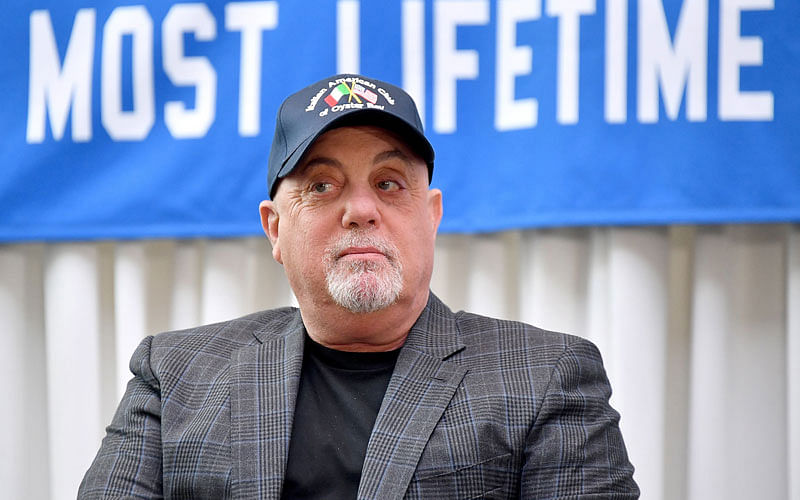 Billy Joel sits in front of the banner honoring his 100th Lifetime Performance at Madison Square Garden on 18 July, 2018 in New York City. Photo: AFP  Billy Joel celebrates 100th show