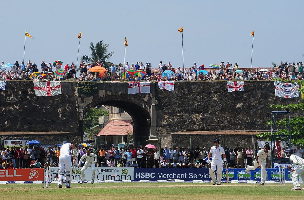 In this file photo taken on 27 March 2012 England cricket team fans watch the second day of the opening Test match between Sri Lanka and England from the top of the 17th century Dutch fort overlooking Galle Stadium in Galle. Photo: AFP