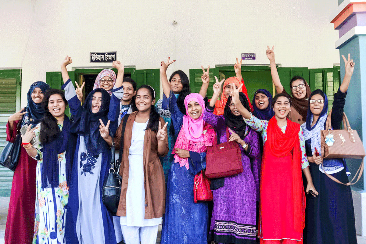 Students of Government Girls College in Barishal show victory sign after the announcement of the results. Photo: Saiyan