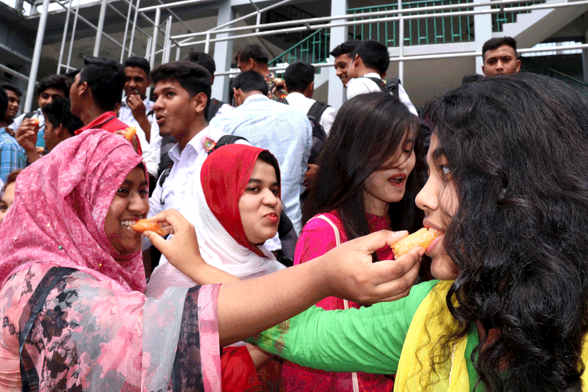 Two students exchange sweets after results in Rangpur Cantonment Public School and College. Photo: Mainul Islam