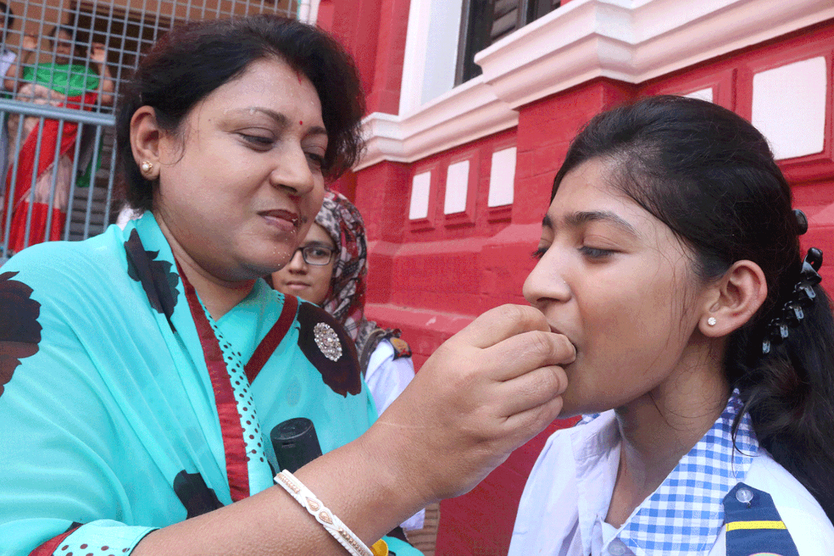 A parent treats her daughter with sweets to celebrate her HSC result in Rajshahi. Photo: Shahidul Islam