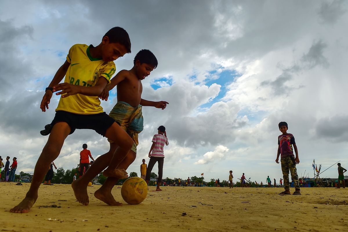In this picture taken on July 19, 2018, Rohingya refugee children play football at the Kutupalong refugee camp in Ukhia. AFP