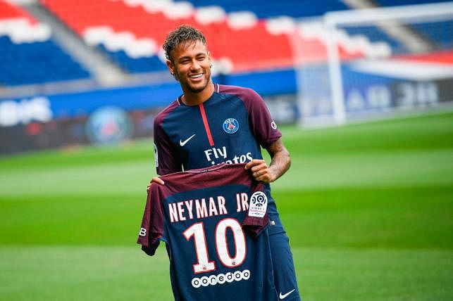 Brazilian superstar Neymar poses with his new jersey during his official presentation at the Parc des Princes stadium on 4 August, 2017 in Paris after agreeing a five-year contract following his world record 222 million euro ($260 million) transfer from Barcelona to Paris Saint Germain`s (PSG). Photo: AFP