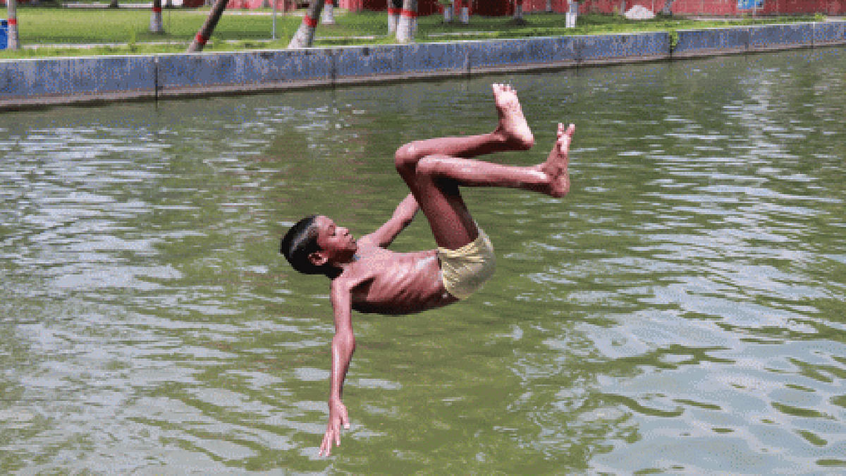 A boy jumps into the pond at Polytechnic Institute, Pabna in scorching heat on 20 July. The photo has been taken by Hasan Mahmud.