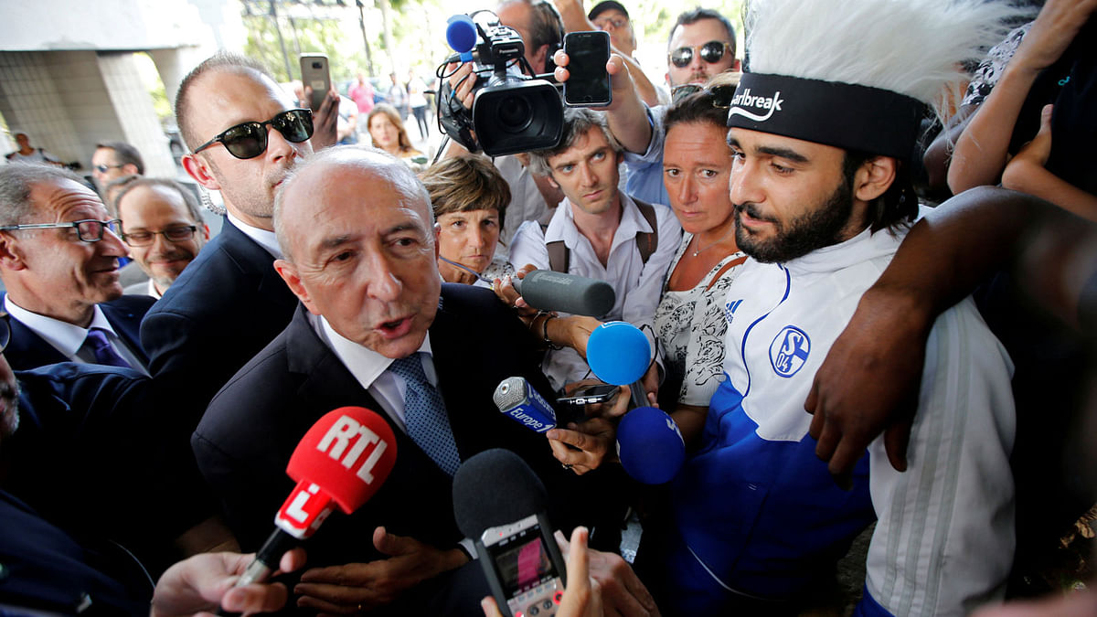 French interior minister Gerard Collomb talks with journalists surrounded by residents during a visit to the Cite de la Castellane housing complex as part of a trip on day-to-day security in Marseille, France on 5 July 2018. Photo: Reuters