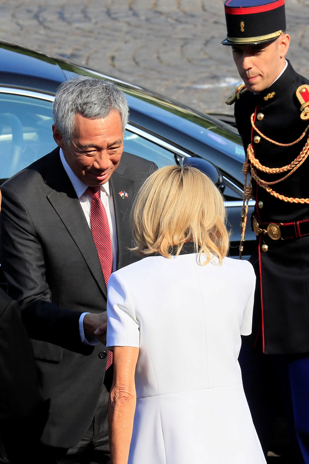 Brigitte Macron, wife of French president Emmanuel Macron, greets Singapore`s prime minister Lee Hsien Loong as he arrives to attend the traditional Bastille Day military parade on the Champs-Elysees Avenue in Paris, France, 14 July 2018. Reuters