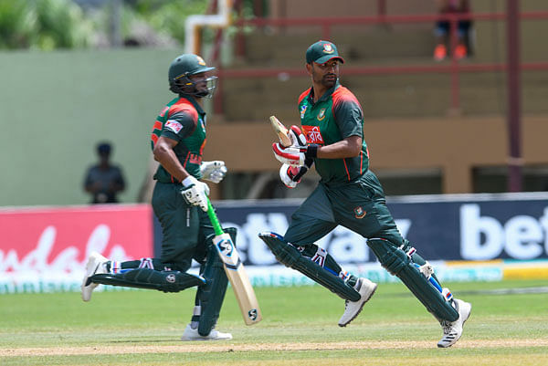 Shakib Al Hasan (L) and Tamim Iqbal (R) of Bangladesh 100 partnership run during the 1st ODI match between West Indies and Bangladesh at Guyana National Stadium, Providence, Guyana, on 22 July 2018. Photo: AFP