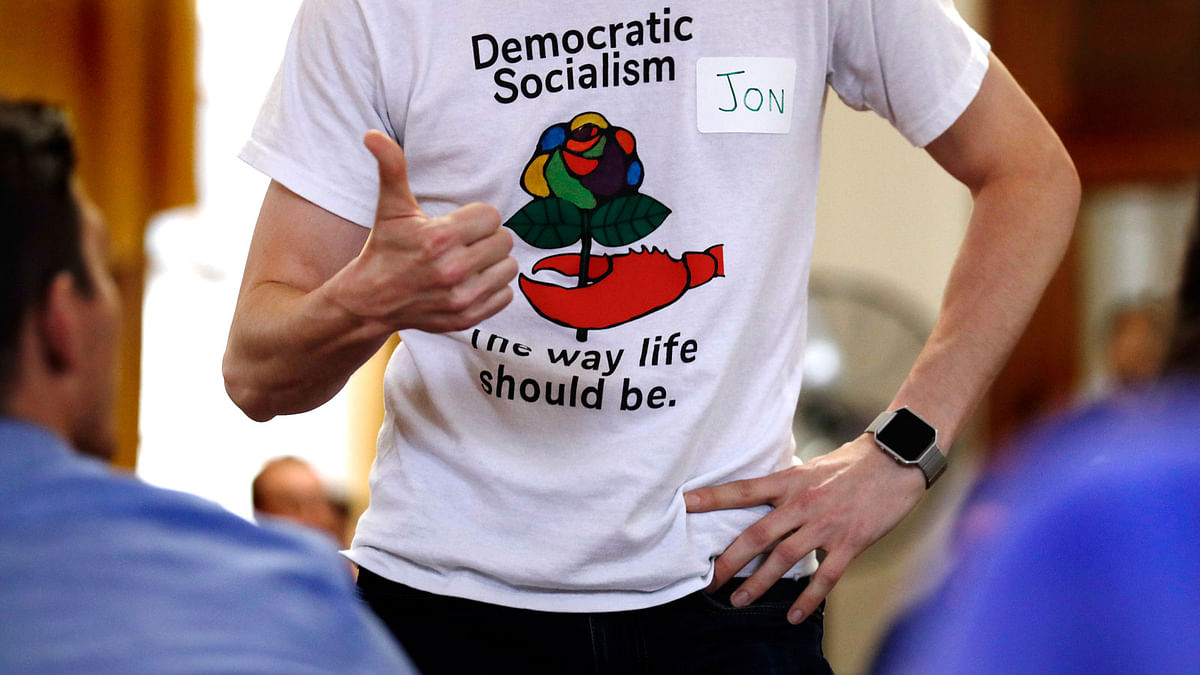 Jon Torsch, center, wears a t-shirt promoting democratic socialism during a gathering of the Southern Maine Democratic Socialists of America at City Hall in Portland, Maine, Monday, 16 July 2018. Photo: AP