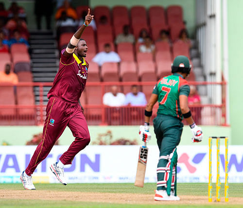 Jason Holder (L) of West Indies celebrates the dismissal of Anamul Haque (R) of Bangladesh during the 1st ODI match between West Indies and Bangladesh at Guyana National Stadium, Providence, Guyana, on Sunday. AFP