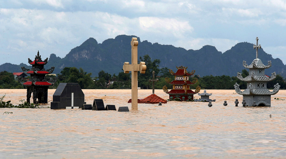 Submerged tombs are seen at a flooded village after heavy rainfall caused by tropical storm Son Tinh in Ninh Binh province, Vietnam, 22 July 2018. Photo: Reuters