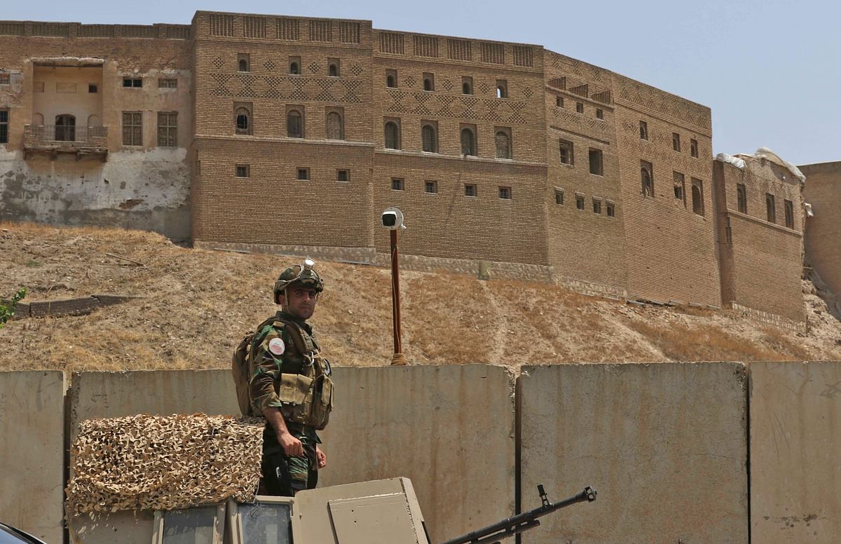 Kurdish soldier stands guard near of the Erbil governorate headquarters after an attack in Erbil, the capital of autonomous Iraqi Kurdistan on 23 July 2018. Photo: AFP