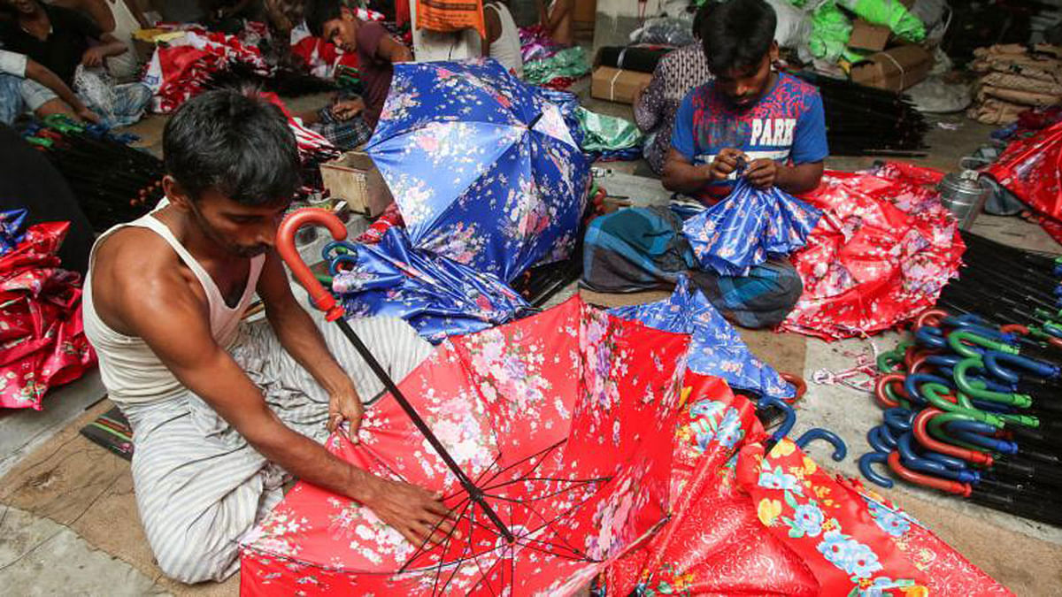 Workers are in an umbrella workshop in Chawk Bazar, Dhaka on 25 July. The umbrella makers are passing busy times due to an increased demand of umbrellas in the rainy season. Photo: Saiful Islam