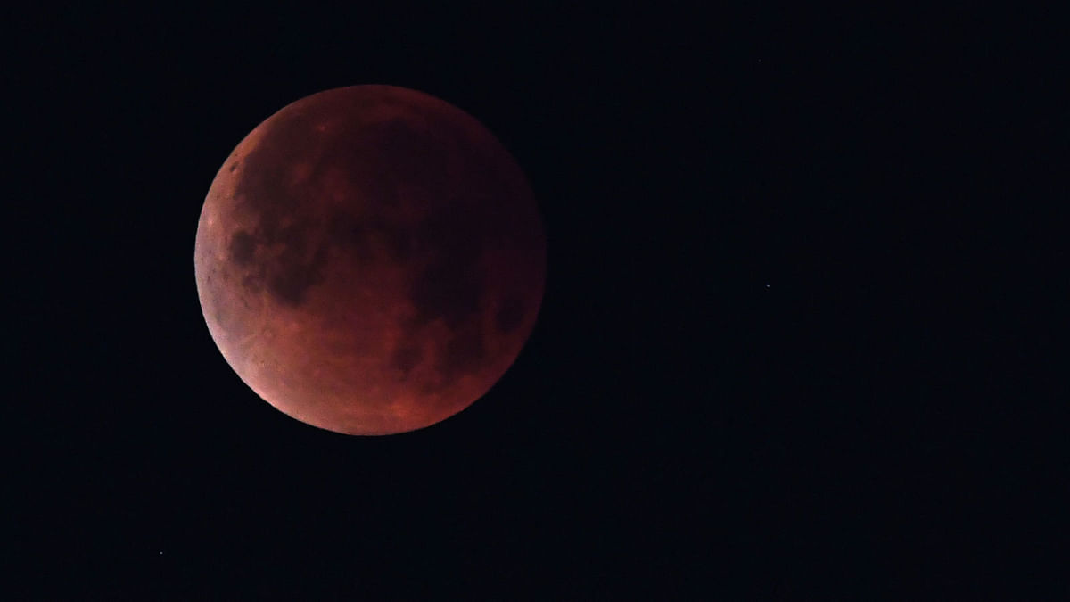 In this file photo taken on 31 January, 2018 the `super blue blood moon` is seen over Los Angeles, California. The longest `blood moon` eclipse this century will coincide with Mars` closest approach in 15 years to offer skygazers a thrilling astronomical double bill on Friday, astronomers say. Photo: AFP