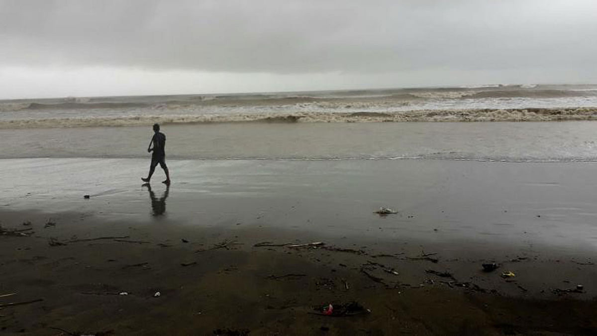 A man walks on Cox’s Bazar beach by the Bay of Bengal. The beach, generally buzzing with tourists, sees a decline in the number of tourists due to hostile weather. The photo was taken by Zahidul Karim on 25 July.