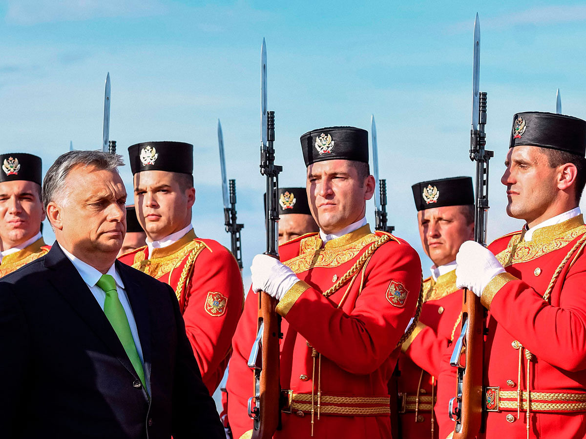 Hungarian prime minister Viktor Orban reviews the honour guard during an official welcome ceremony at Podgorica airport on 23 July 2018. Photo: AFP