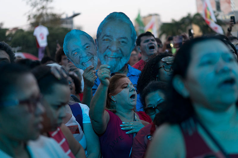 A woman holds up a mask depicting the former Brazilian President Luiz Inacio da Silva during the Lula Free festival, in Rio de Janeiro, Brazil on 28 July. Photo: AP