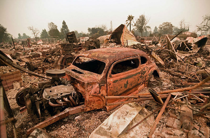 A destroyed car is seen among the ruins of a burned neighborhood after the Carr fire passed through the area of Lake Keswick Estates near Redding, California on 28 July. Photo: AFP