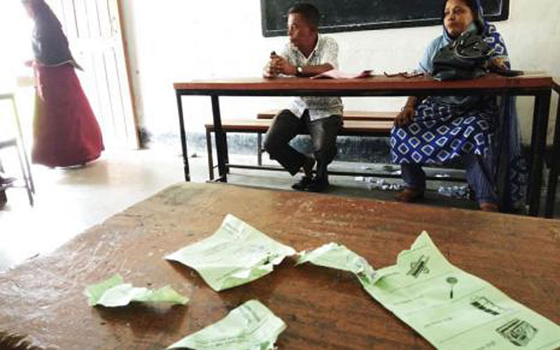 Ballot papers are torn off while ruling Awami League activists allegedly try to snatch the ballot papers in a polling station of ward 18 in Sylhet city corporation election on Monday. Photo: Shuvra Kanti Das
