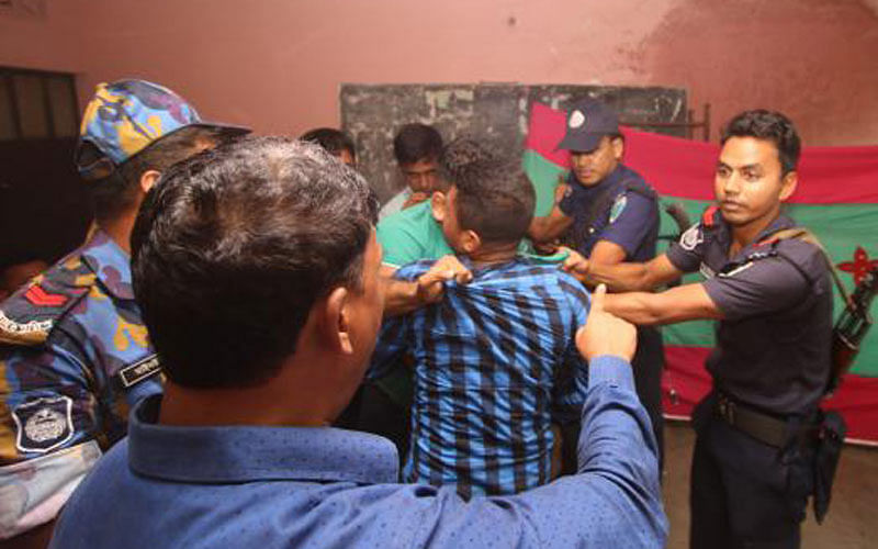 Police detain a group of youths when they were stamping on the ruling party`s election symbol `boat` at the Shylhet Railway Government Primary School polling station during civic polls in Sylhet on 30 July. Photo: Abdus Salam