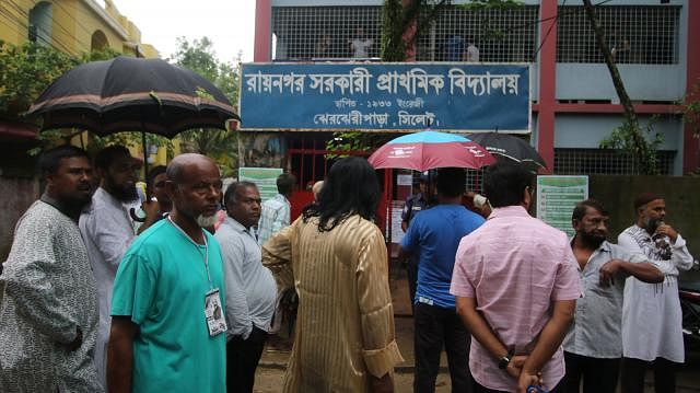 Voters stand in front of Raynagar Govt Primary School centre in Sylhet city. Photo: Abdus Salam