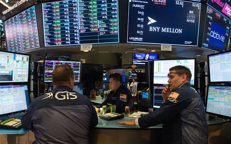 In this file photo taken on 30 January 2014 Traders work on the floor at the closing bell of the Dow Industrial Average at the New York Stock Exchange on 19 July 2018 in New York. The US economy roared to life in the second quarter, posting the fastest annual growth rate in almost four years and the strongest among industrialized nations, according to government data released on 27 July 2018. -- AFP