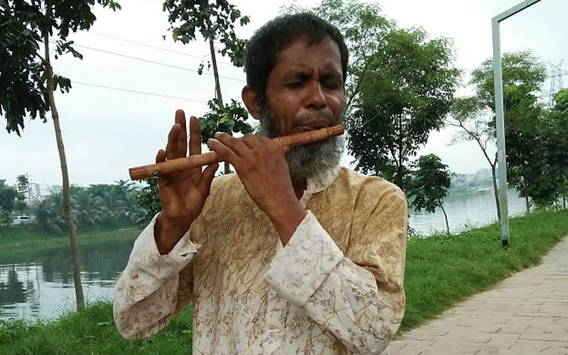 Shameem Miah, 50, from Rampura said he was not sure whether he could survive a surgery. But he would be happy to play his flute again. The photo was taken from Hatirjheel, Dhaka recently by Nusrat Nowrin.
