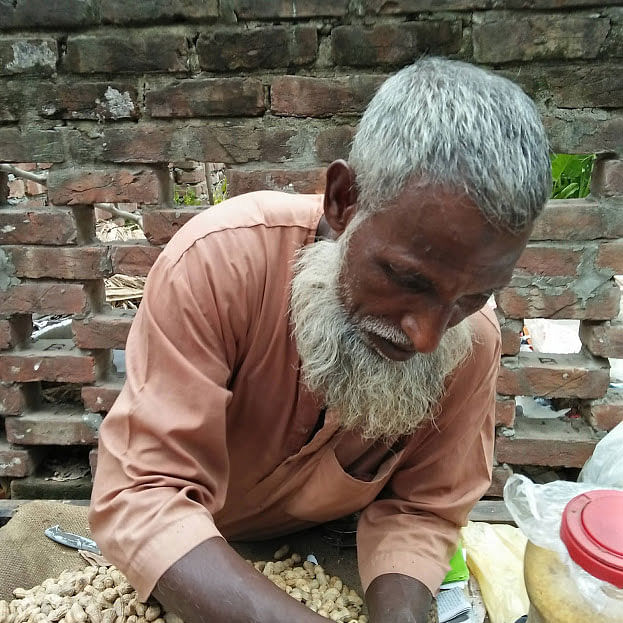 Asad Miah, 63, sells peanuts, corn and chickpeas on the street. Happiness means self-reliance to him. The picture was taken from Mahanagar Housing Society, Hatirjheel, Dhaka recently by Nusrat Nowrin