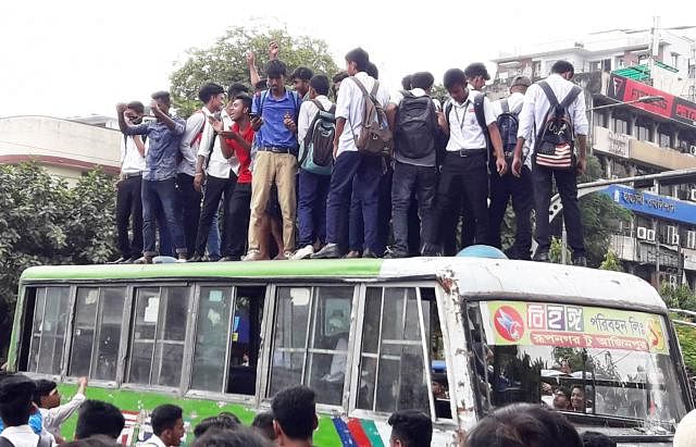 Students on a bus roof at Science Laboratory, Dhaka on Wednesday during a student protest against the death of two students killed in a road crash in the city on Sunday. Photo: Mosabber Hossain