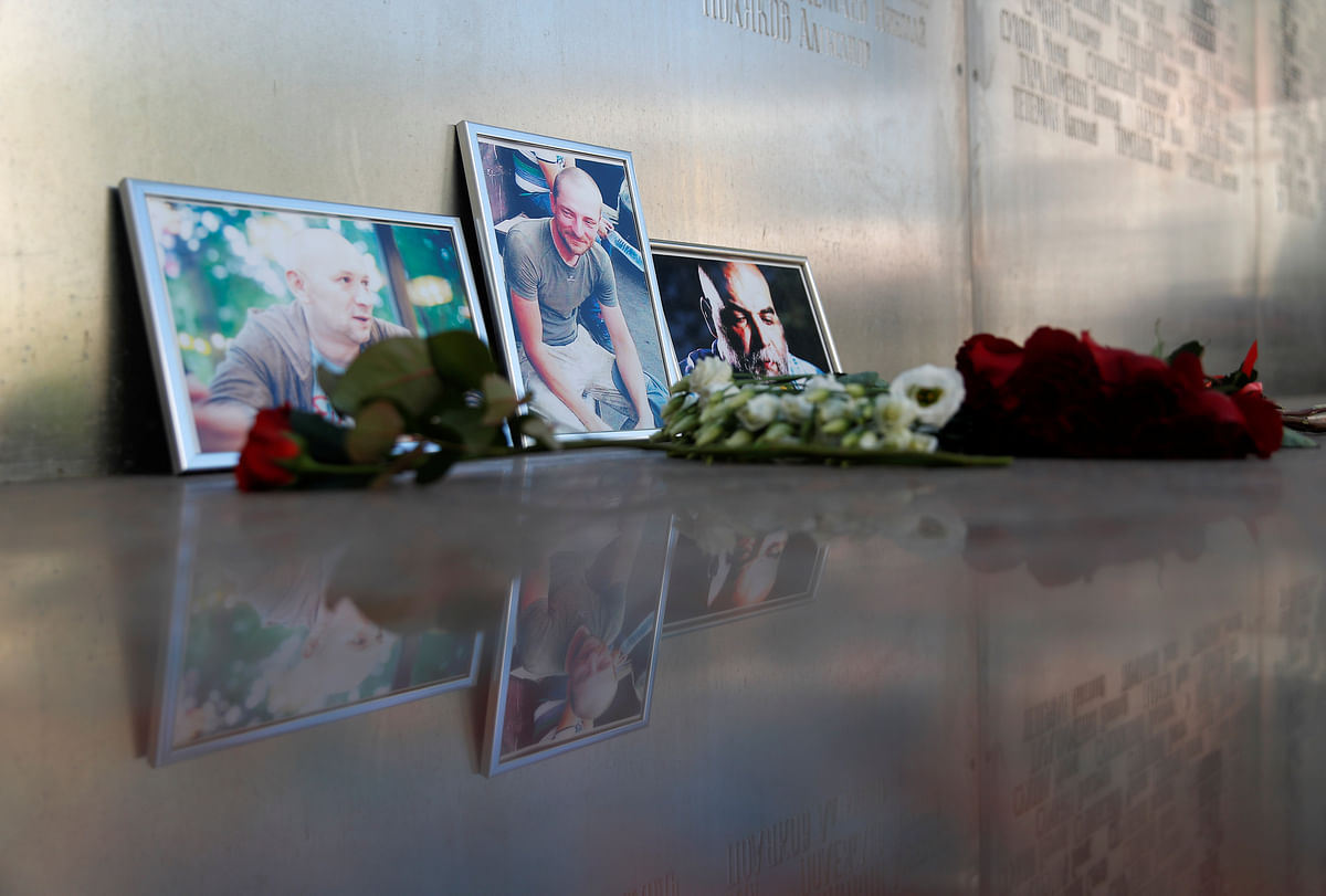 Photographs of journalists, (R-L) Orhan Dzhemal, Kirill Radchenko and Alexander Rastorguyev, who were recently killed in Central African Republic by unidentified assailants, are on display outside the Central House of Journalists in Moscow, Russia on 1 August 2018. Photo: Reuters