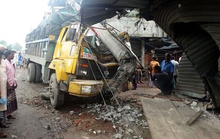A truck, losing control, hit the electric pole and crashed into a fruit shop at Charmatha intersection, Hatkhola Road, Bogura on 1 August. The driver and conductor ran away after the incident. Photo: Sabuj Chowdhury
