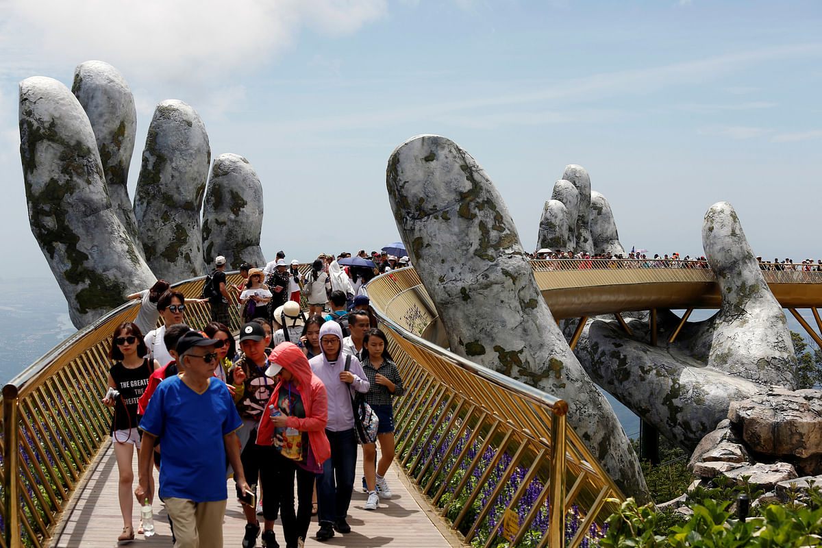 Tourists walk along Gold Bridge on Ba Na hill near Danang city, Vietnam, on 1 August 2018. Photo: Reuters