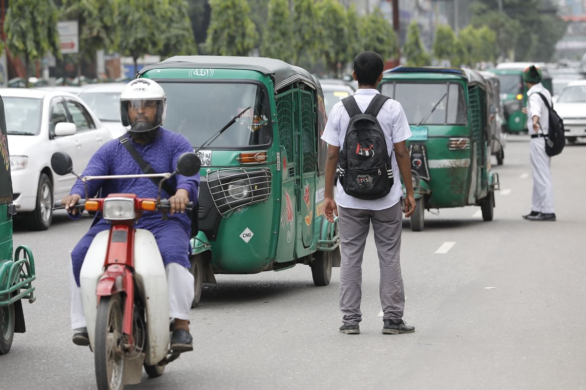The students are seen working to impose discipline on the streets of Dhaka in the Asad Gate area of Mohammadpur on Friday morning. Photo: Dipu Malakar