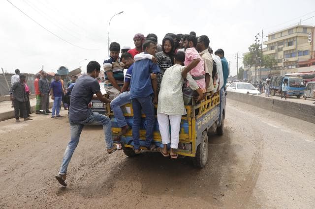 People board a pick-up van for the absence of public transport vehicles to go from one place to another on Friday. Photo: Dipu Malakar