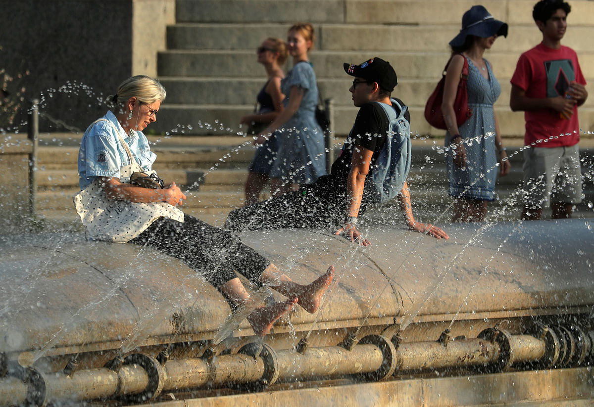 People cool off at a public fountain in Vienna, Austria on 3 August. Photo: Reuters