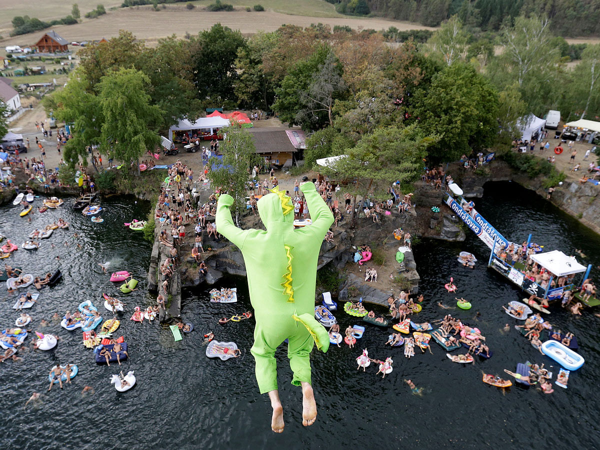 A competitor jumps into the water during a cliff diving competition near the central Bohemian village of Hrimezdice, Czech Republic on 3 August. Photo: Reuters