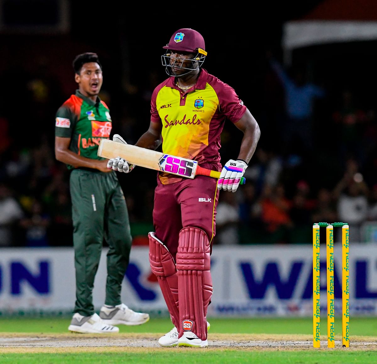 Andre Russell (R) of West Indies is dismissed by Mustafizur Rahman (L) of Bangladesh during the 2nd T20I match between West Indies and Bangladesh at Central Broward Regional Park Stadium in Fort Lauderdale, Florida, on 4 August 2018. Photo: AFP