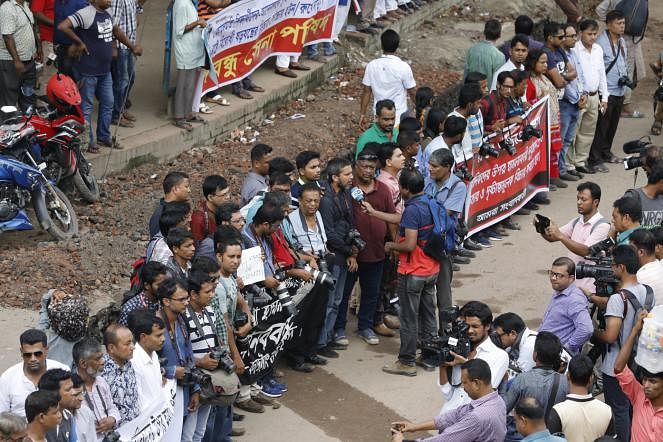 Photojournalists during a human chain formed at National Press Club area near Topkhana Road, Dhaka on 7 August. The participants denounced attacks on journalists while covering the student protest movement this week. Photo: Dipu Malakar